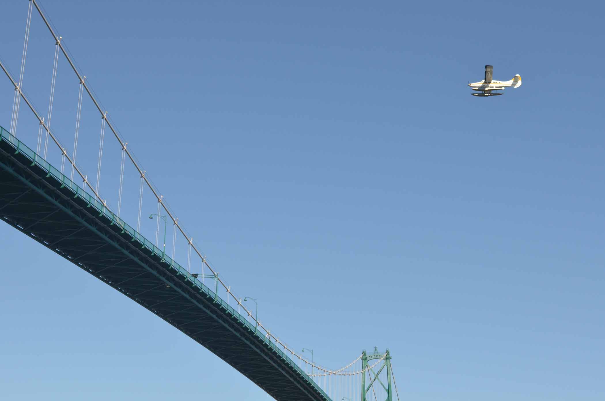 Seaplane Crossing Lions Gate Bridge in Vancouver Stanley Park